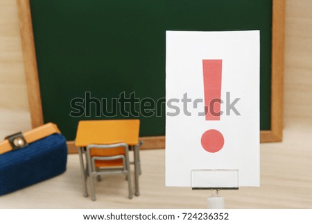 Exclamation mark on white paper with the study tool as the background.
Concept of learning inspiration.