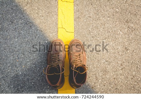 leather shoes near yellow street line in concept travel , vacation 