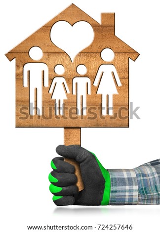 Hand with work glove holding a wooden model house with a symbol of family and heart. Isolated on a white background