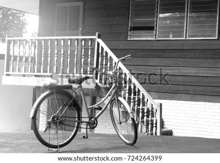vintage bicycle on vintage wooden house wall.