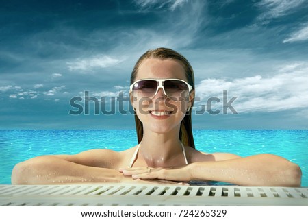 Beautiful happiness girl in white bikini stay in the waterpool