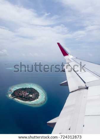 Beautiful picture of resort at atoll in Maldives taking picture from airplane view