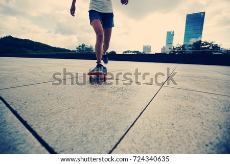 woman skateboarder skateboarding at city