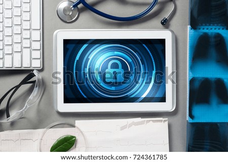Doctors workplace with white tablet stethoscope and mask