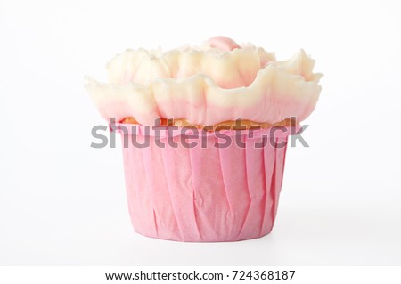 Pink cupcake with white whipped cream in form of flower on white background. Picture for a menu or a confectionery catalog. Cutout.