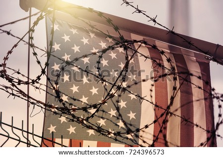 American flag and barbed wire, USA border Royalty-Free Stock Photo #724396573