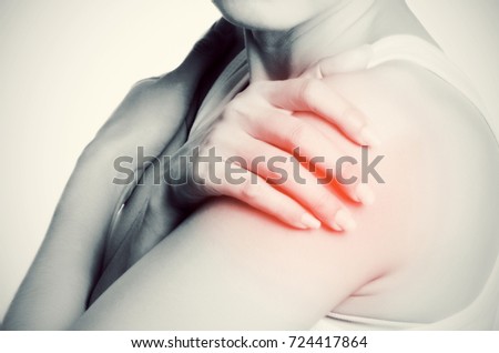 Asian woman with pain in shoulder., Black and white photo of pain highlighted by red dots. Close-up photo.