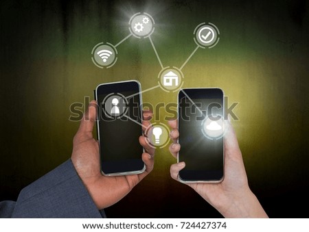 Digital composite of Hands holding phones with icons interface of internet of things