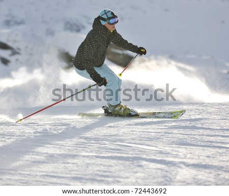 young healthy woman skiing on fresh snow at winter season in france alps