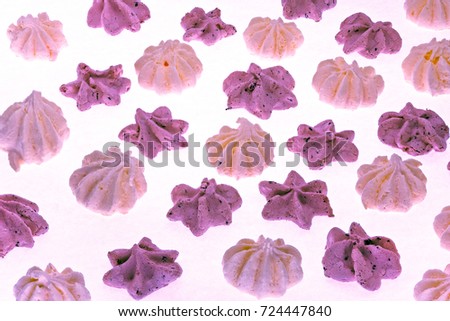 Colorful meringues on white. Many sweet zephyrs pattern background. Trendy top view dessert image. Bakery products top view. Colorful cookies background. stars and flowers meringues lay one by one.