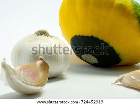 spotted squash on a white background and garlic