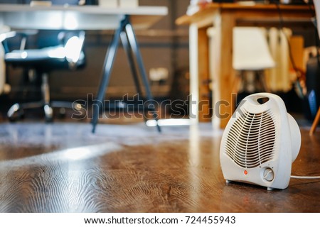 autumn concept and technology. air heater in the office. Royalty-Free Stock Photo #724455943