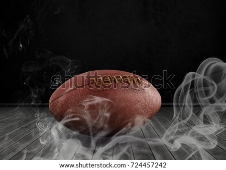 Digital composite of american football in smoke