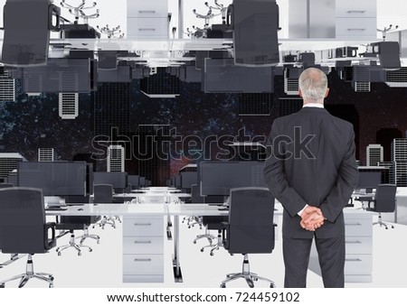 Digital composite of businessman standing in inverted office with skyline