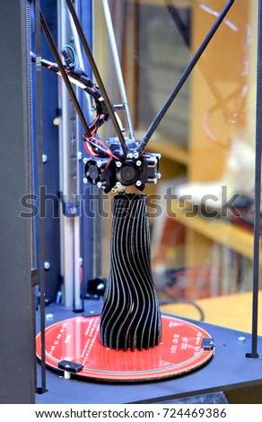 A black vase made on a 3d printer stands on the work surface close-up. Progressive modern additive technologies 4.0 industrial revolution