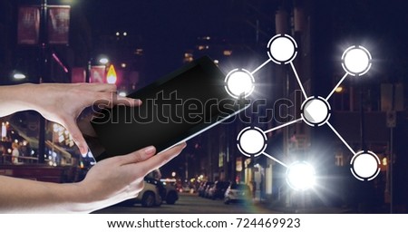 Digital composite of Hand holding tablet with icons interface of internet of things