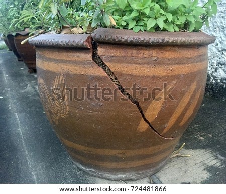 Broken Pot with the other in a Row Royalty-Free Stock Photo #724481866