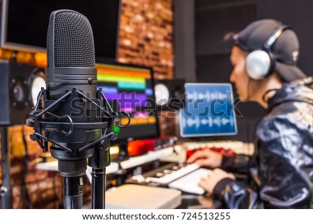 studio condenser microphone on sound engineer working in control room background. recording, broadcasting concept Royalty-Free Stock Photo #724513255