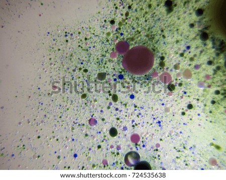 Watercolor paint dissolves in water droplets on the glass, backlighting from different directions, large magnification, bokeh, Colored abstractions, Painted oil drops on the water,