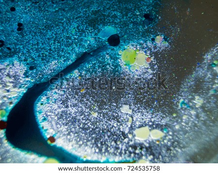 Watercolor paint dissolves in water droplets on the glass, backlighting from different directions, large magnification, bokeh, Colored abstractions, Painted oil drops on the water,