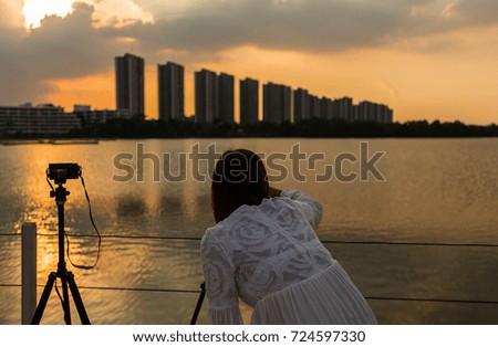 Woman Photography with city-scape , sunset 