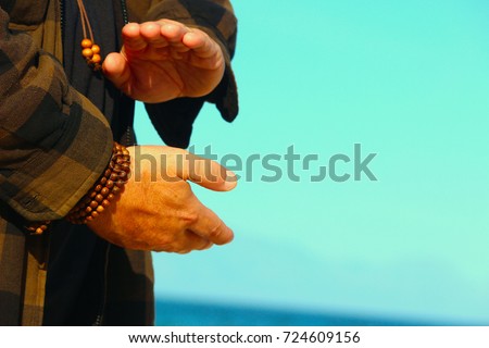 close up of a man's hands  doing Qigong routine, holding a ball of chi Royalty-Free Stock Photo #724609156