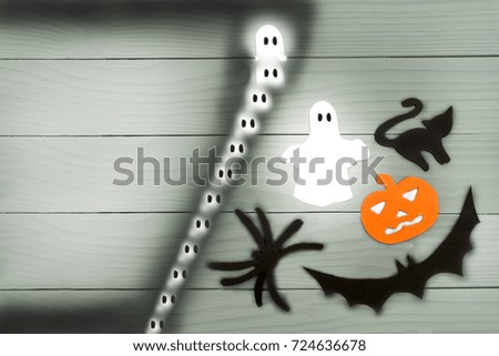 Top view of Halloween paper silhouette of different characters made of horizontal frame on grey wooden background. Halloween holiday concept. Copy space