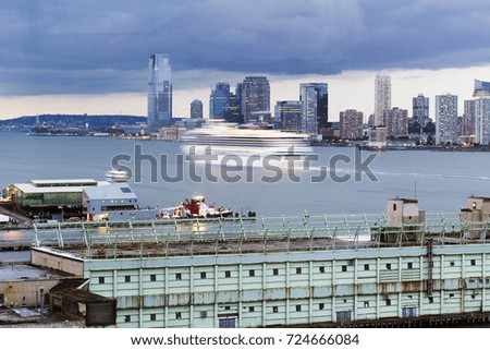 A cruise ship in motion on Hudson river between New York City and New Jersey
