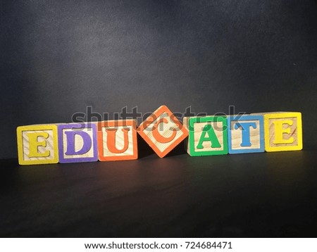 Toy wooden blocks spelling out educate