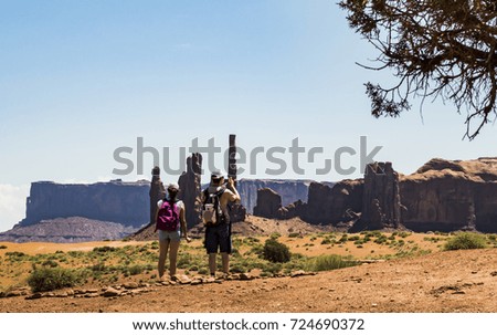 Couple of tourists taking pictures at Three Sisters, Monument Valley - Arizona, AZ, USA