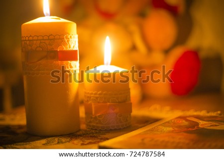 reading books at night under the light of a candle