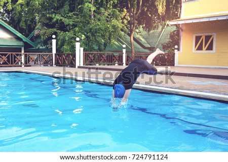  young woman jumping into the swimming pools