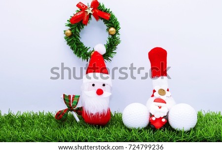 Santa with Christmas wreath and golf ball on green grass