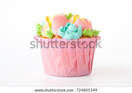 Pink cupcake with white whipped cream in form of flower on white background. Picture for a menu or a confectionery catalog. Cutout.