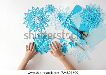 Making of snowflakes from paper Royalty-Free Stock Photo #724801600