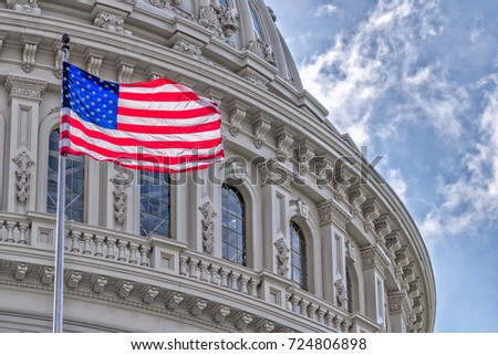Washington DC Capitol dome detail with waving american flag Royalty-Free Stock Photo #724806898