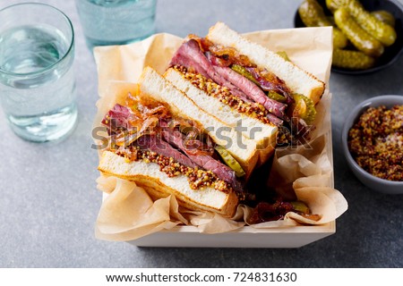 Sandwich with roast beef in wooden box. Close up.