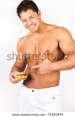 Muscular male body with tasty burger