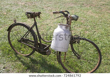 very old bicycle with aluminum milk bin to carry milk just moistened