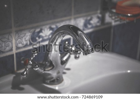 Water tap in bathroom. Selective focus, toned
