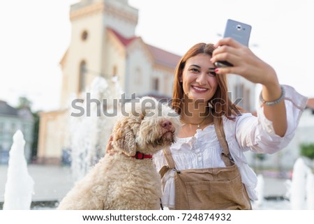 Dogs give us a sense of purpose. Woman taking selfie with her dog outdoor