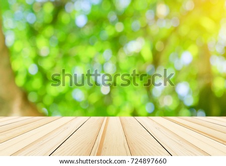 wooden table with blurred city park on background
