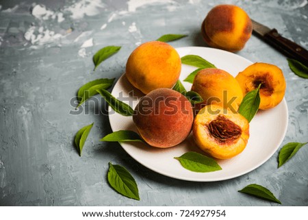 Fresh ripe peaches on the rustic background. Selective focus.