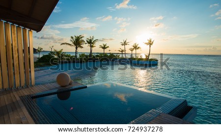 Luxury swimming pool near beach front Royalty-Free Stock Photo #724937278