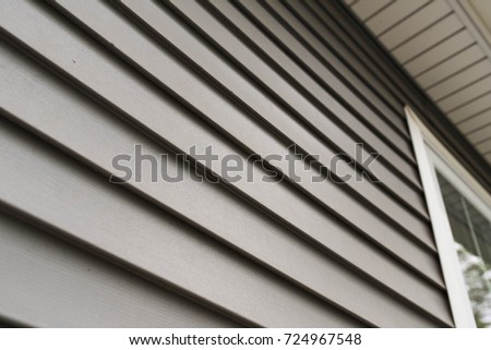 Close up look at vinyl siding on a new home. Royalty-Free Stock Photo #724967548