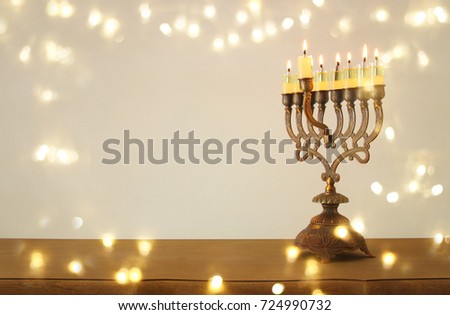 Image of jewish holiday Hanukkah background with menorah (traditional candelabra) and burning candles.