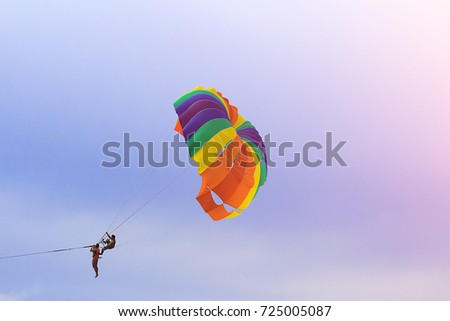 Playing a parasailing on the beach and it is flying up into the sky at Phuket Patong Thailand