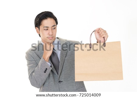 Smiling businessman with a shopping bag