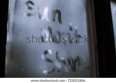 sad inscription on the window sun don`t shine