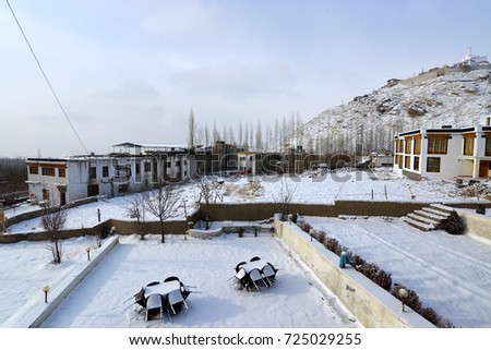 Snow ground view in local guesthouse with the monastery pagoda on the hilltop background in the winter, north India.
